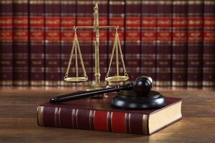 Mallet And Legal Book With Justice Scale On Table